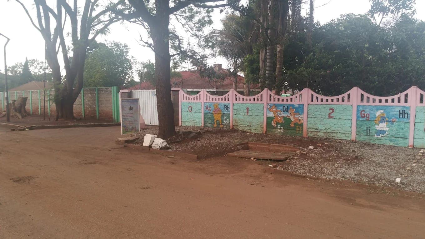 The street front of Nirmeen on Eastcourt Rd, Belvedere: a pink and green wall painted with letters and cartoon characters